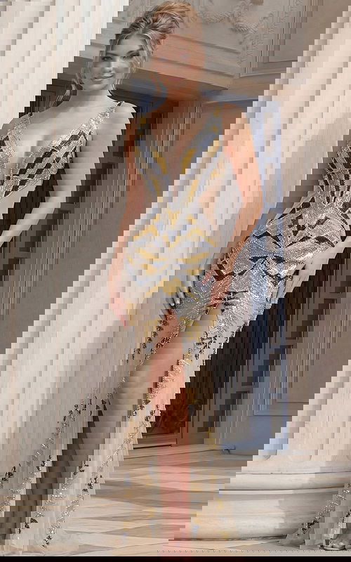 Sleeveless V neck gown with geometric beading, fitted silhouette, and front slit