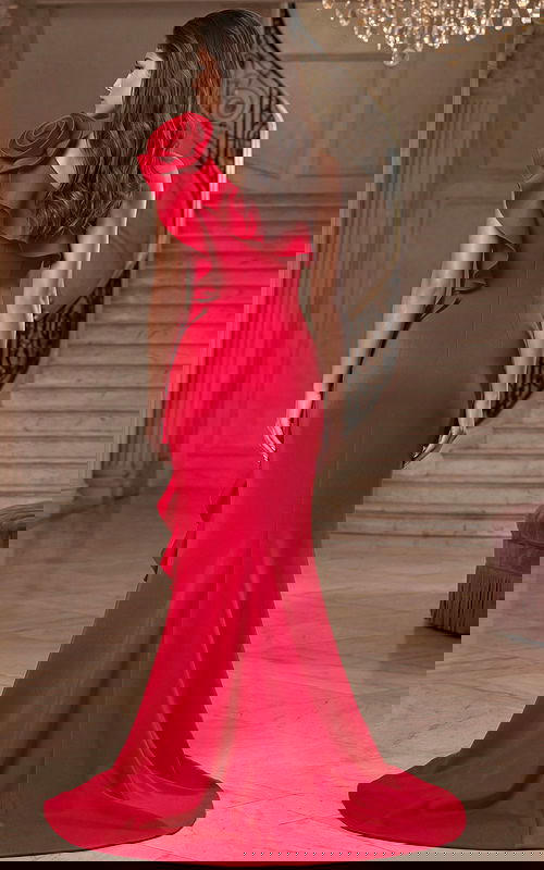 Back view of fitted gown with one shoulder ruffle and flowing train