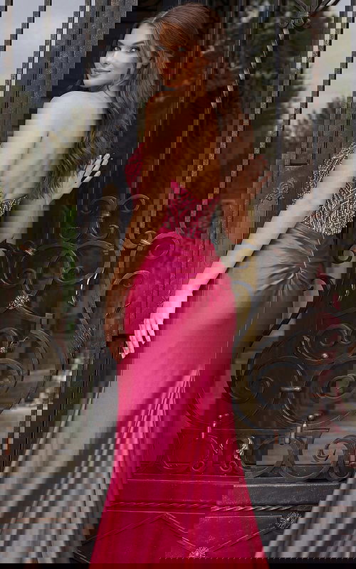 Back view of strapless satin evening dress with beaded bodice, ruched waist detail, and fitted skir