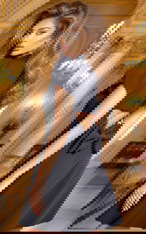 Short black dress with open back detail and bow accent