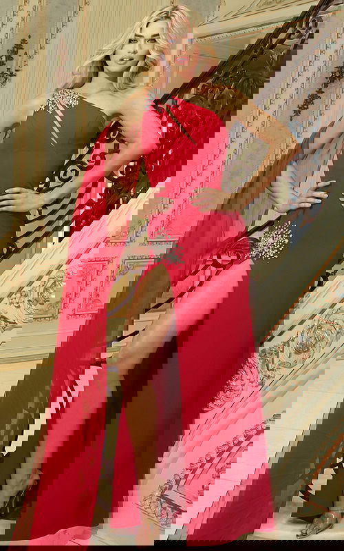 Elegant high slit gown with beaded detailing and flowing drape