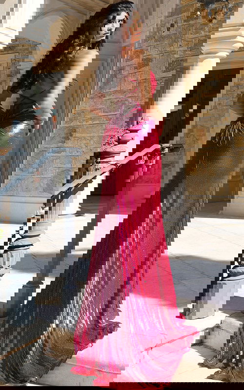 Shiny fuchsia gown with thigh-high slit and form-fitting silhouette